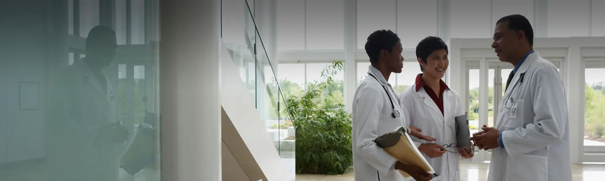 Infectious disease doctors talking in a hospital corridor