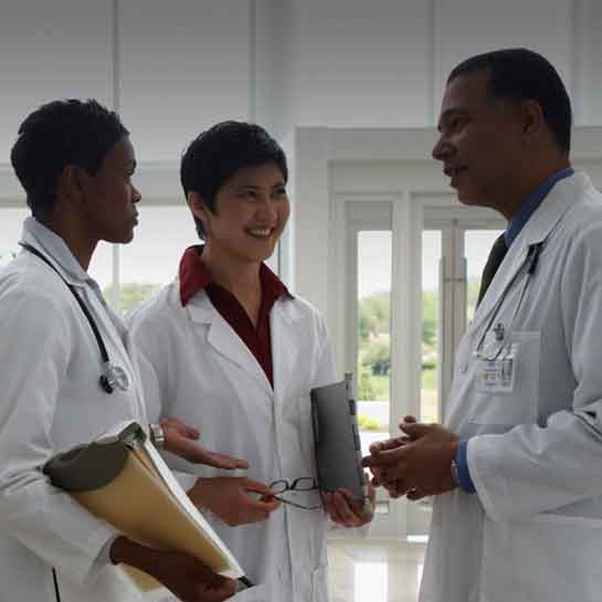 Infectious disease doctors talking in a hospital corridor