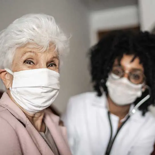 Nursing home employee consulting with patient