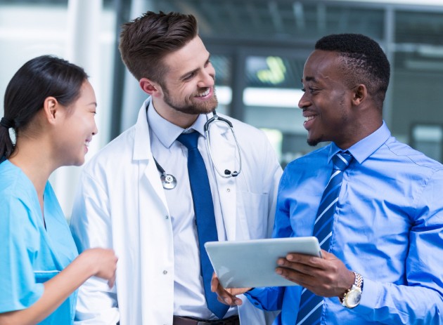 Nurse and doctor having a discussion with businessman