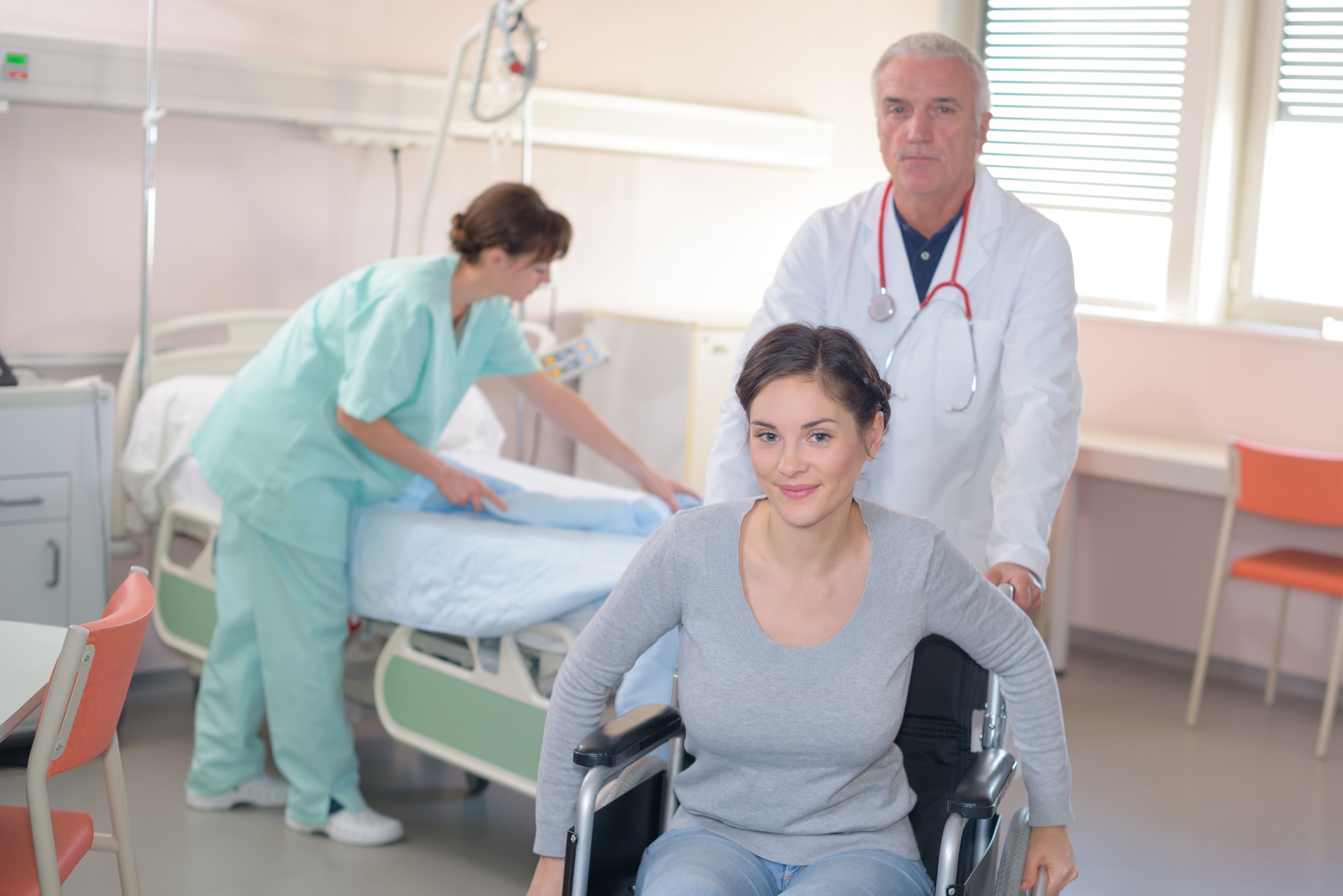 Woman being discharged from the hospital in a wheelchair | Blog on C. auris treatment | ID Care | New Jersey